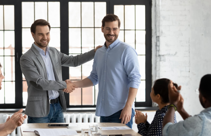 Hireloft Recruitment Agency a exert team member shaking hands with her office colleague
